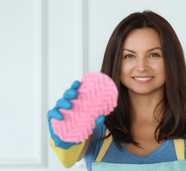 Young woman with rubber gloves ready to clean